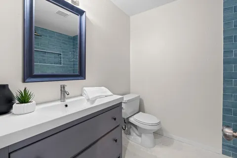 a bathroom with a sink a toilet and a mirror