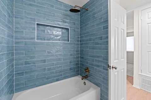 a bathroom with a tub and a shower