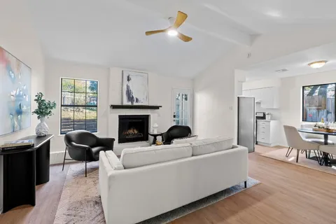 a living room with furniture fireplace and window