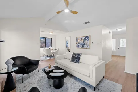 a living room with furniture and a chandelier