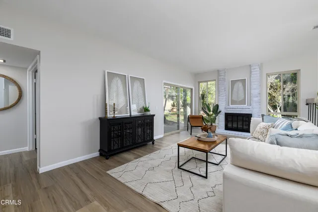 a living room with furniture a window and a fireplace