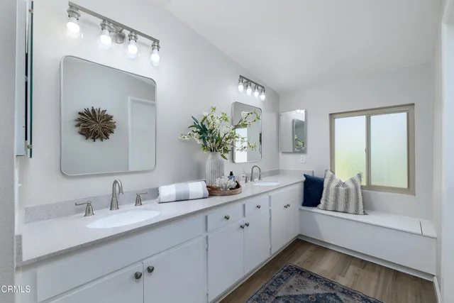 a en suite bathroom with double vanity and a mirror