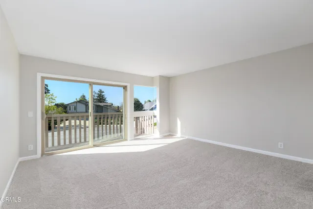 a view of an empty room with a balcony
