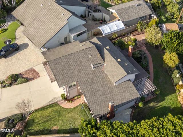 an aerial view of a house with yard