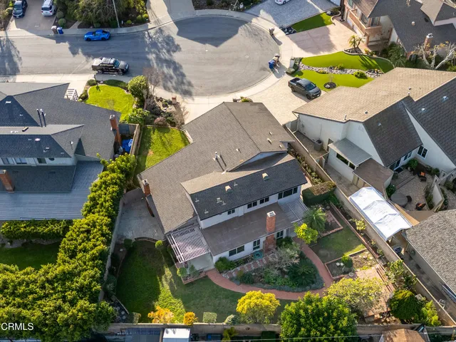 an aerial view of house with a backyard and swimming pool