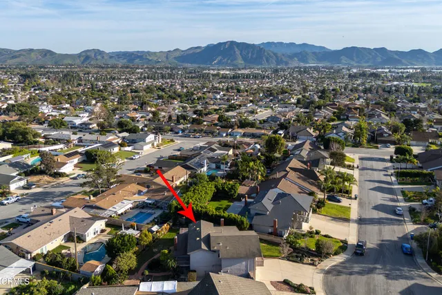 an aerial view of residential house and car parked