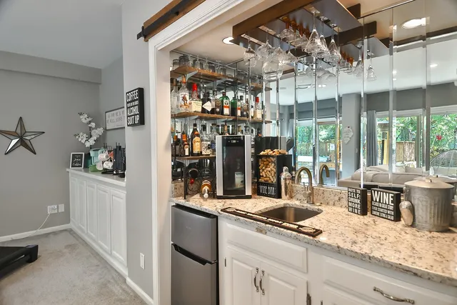 a kitchen with stainless steel appliances granite countertop a sink and cabinets