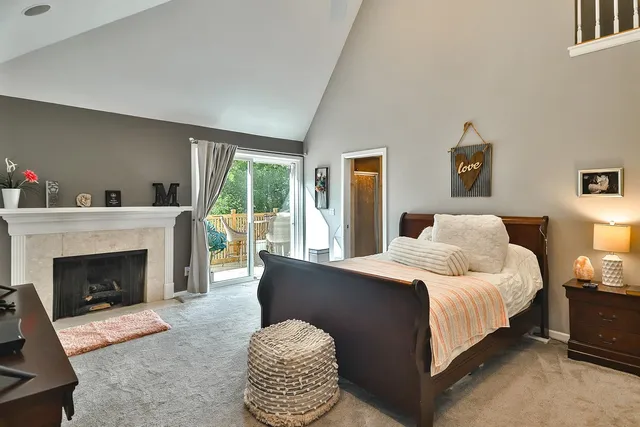 a bedroom with bed and a fireplace