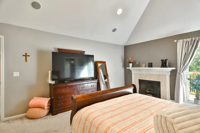 a bedroom with bed and a a chandelier