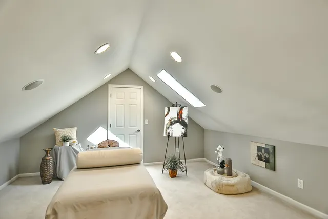 a bathroom with a tub sink and mirror