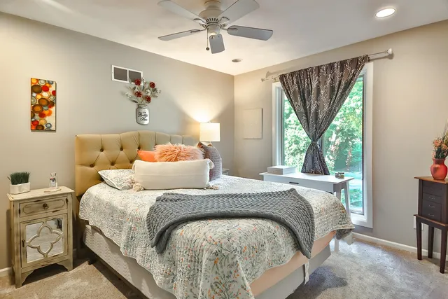 a bedroom with a bed and a table in it