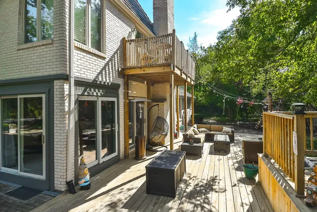 a view of a patio with table and chairs with wooden fence and plants