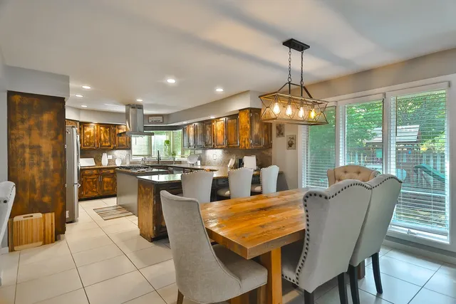 a view of a dining room with furniture wooden floor and a chandelier