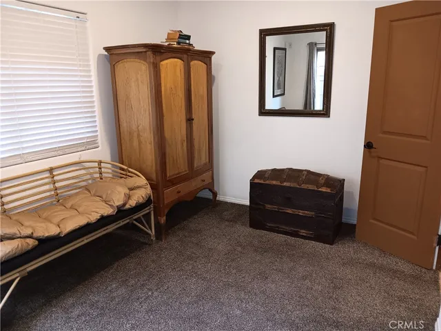 a bedroom with a bed and a mirror