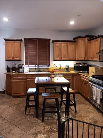 a kitchen with a chair and cabinets