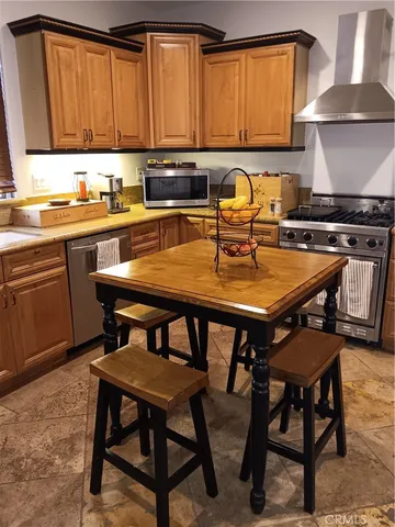 a kitchen with a dining table and chairs