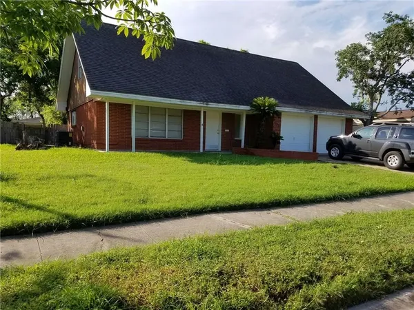a front view of a house with a garden and yard