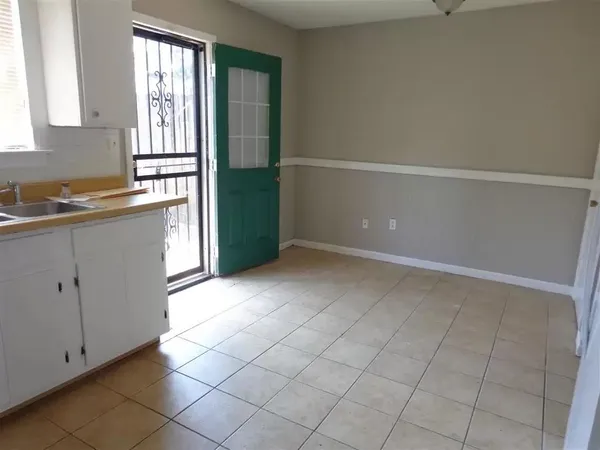 a view of kitchen with entryway sink and cabinets
