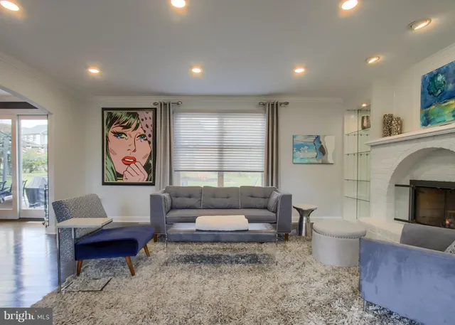 a view of a a dining room with furniture window and wooden floor