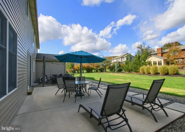 a view of a patio with table and chairs and potted plants