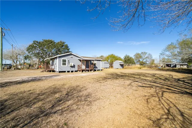 a yellow house with trees in front of it