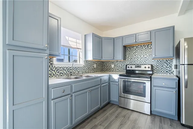 a kitchen with stainless steel appliances granite countertop a stove and a sink