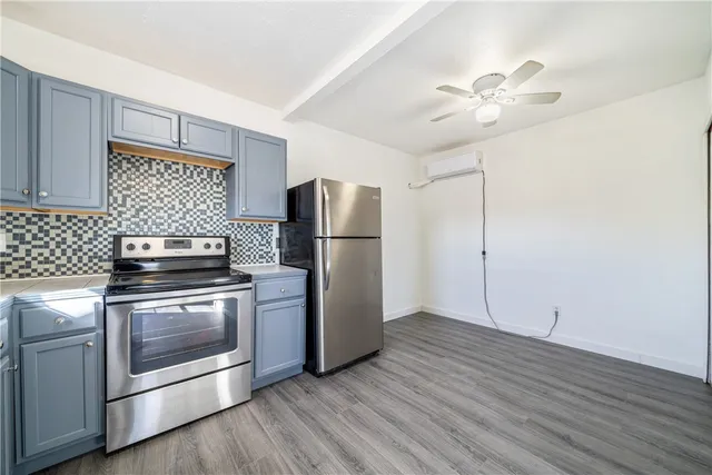 a kitchen with a stove refrigerator and microwave