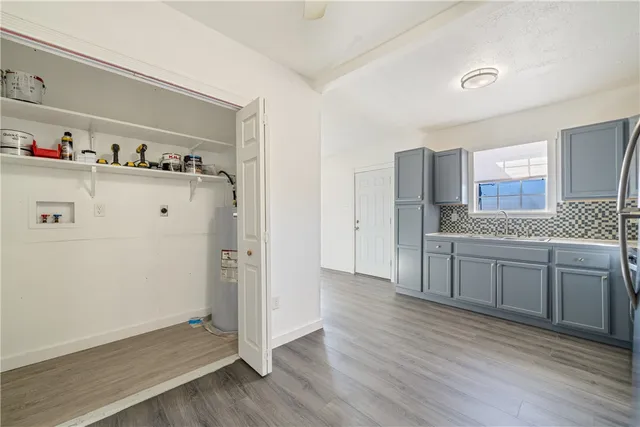 a kitchen with a refrigerator cabinets and wooden floor