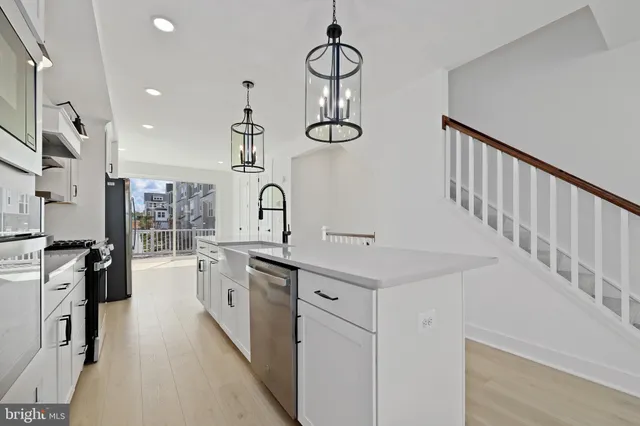 a kitchen with cabinets and stainless steel appliances