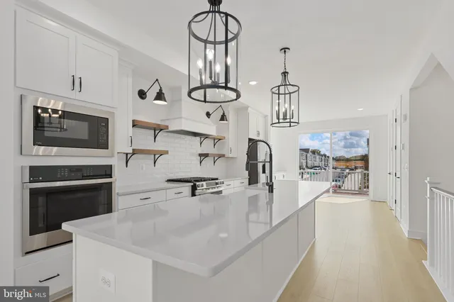 a kitchen with cabinets and stainless steel appliances