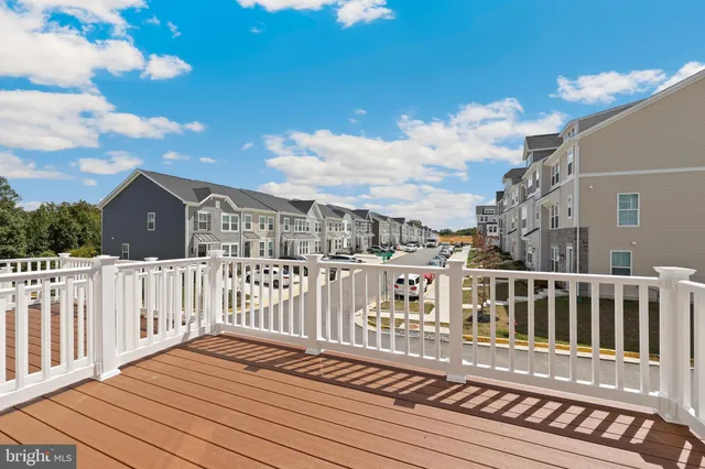 a view of a house with wooden deck