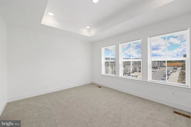 a view of bathroom with a toilet a sink and mirror