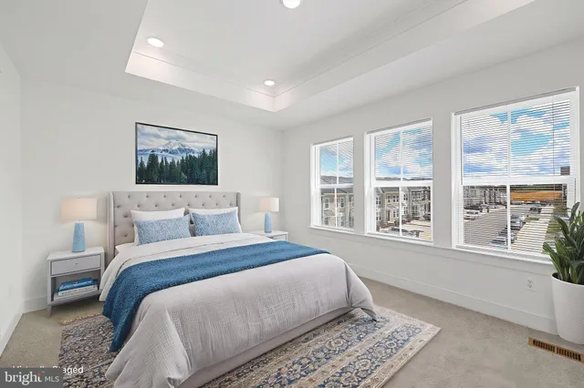 a spacious bedroom with a large bed and a window