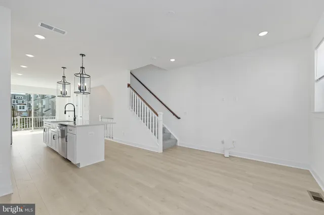 a view of kitchen and hall with wooden floor