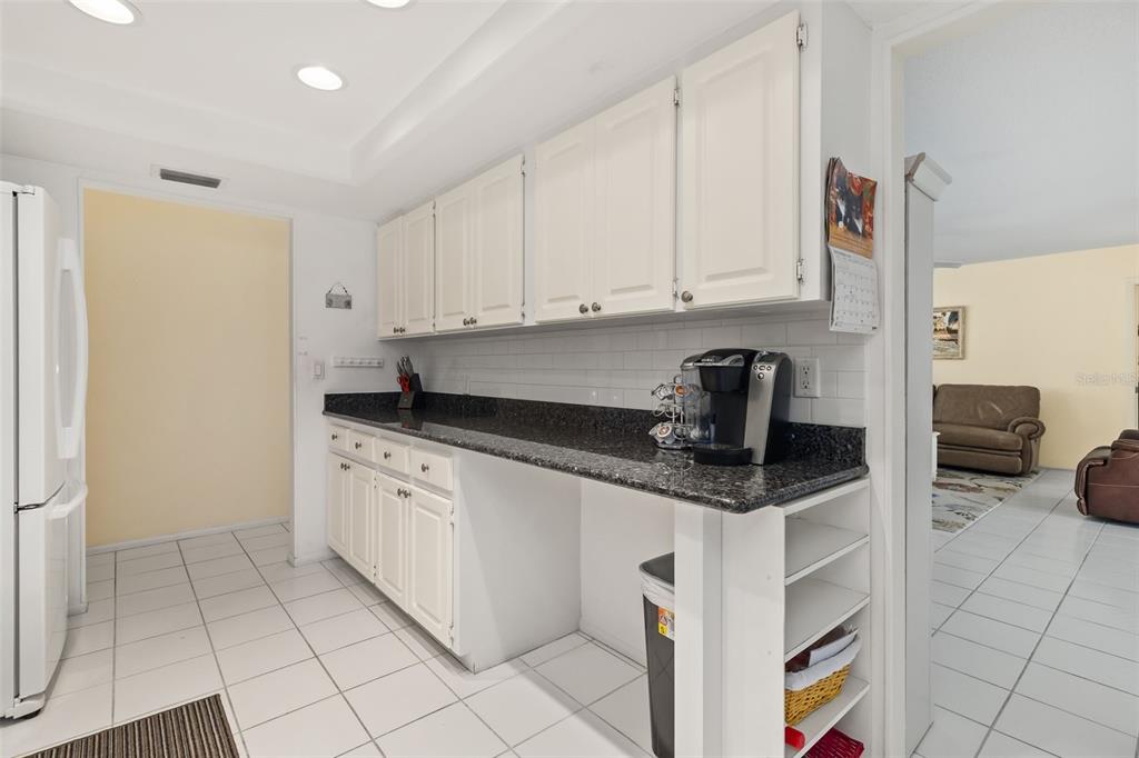 440 Darling Drive Venice, FL 34285 - Photo 13 of 74 a kitchen with granite countertop a sink and a stove top oven