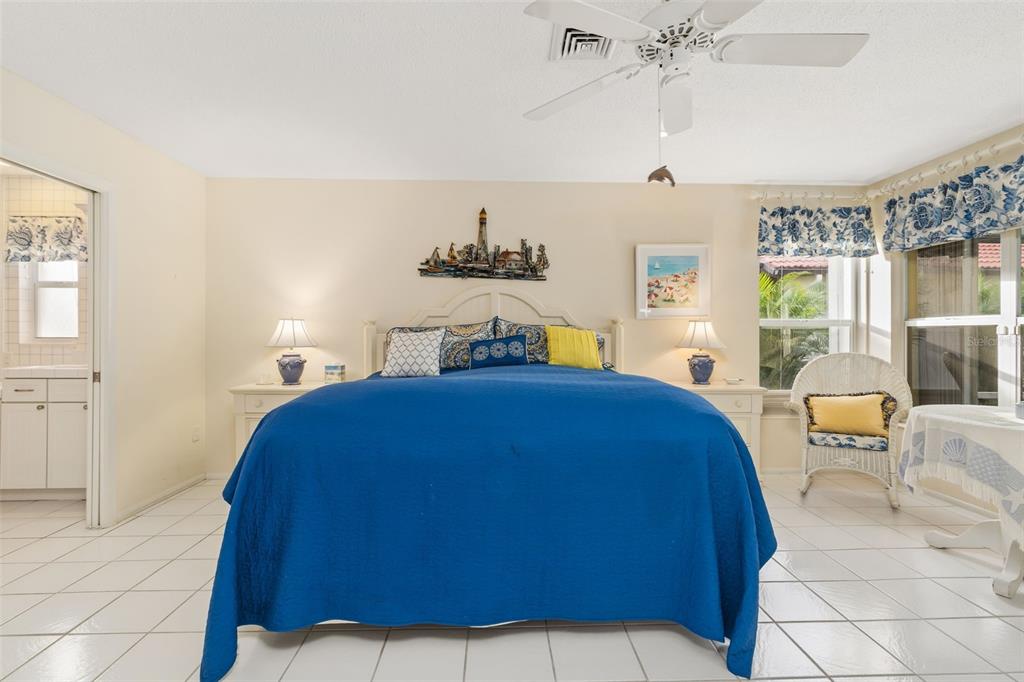440 Darling Drive Venice, FL 34285 - Photo 15 of 74 a bedroom with a large bed and a chandelier