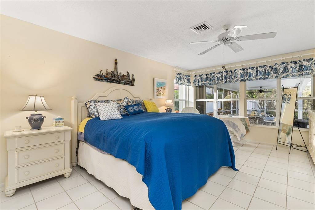 440 Darling Drive Venice, FL 34285 - Photo 16 of 74 a bedroom with a bed and ceiling fan