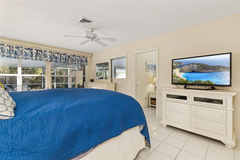 440 Darling Drive Venice, FL 34285 - Photo 17 of 74 a bedroom with a bed and a flat screen tv