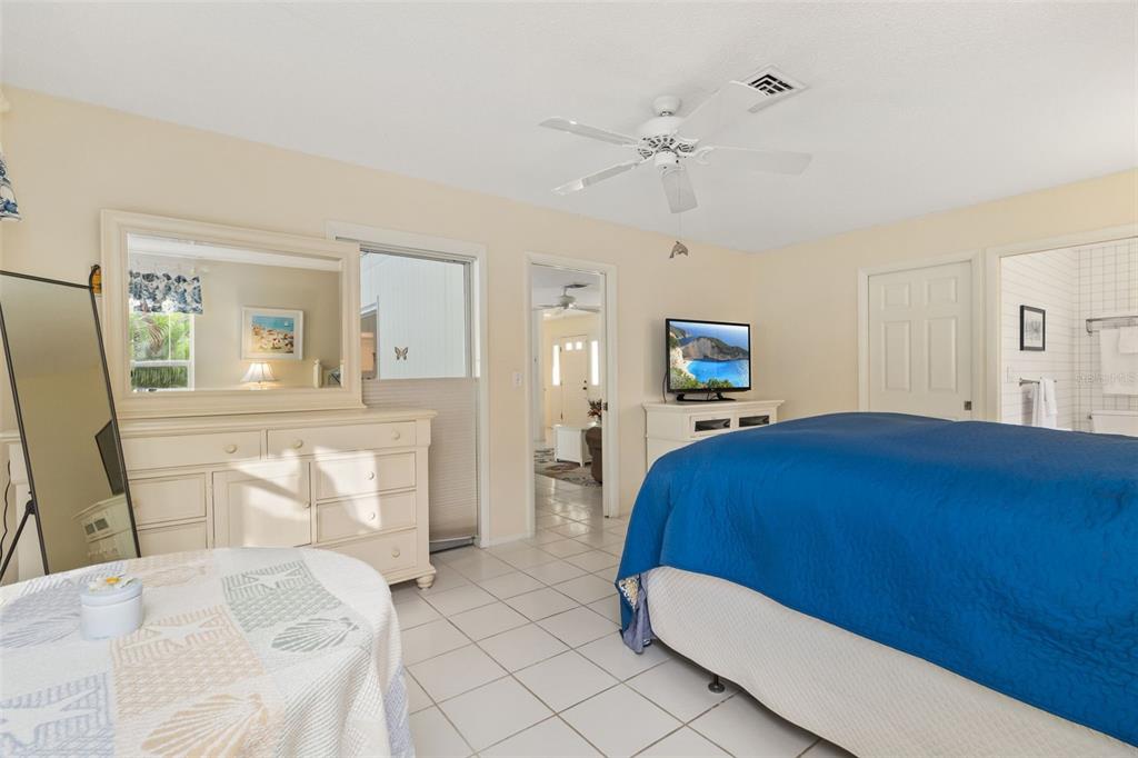 440 Darling Drive Venice, FL 34285 - Photo 18 of 74 a bedroom with a bed and a chandelier