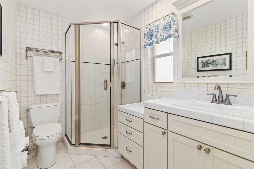 440 Darling Drive Venice, FL 34285 - Photo 19 of 74 a bathroom with a granite countertop sink a toilet and shower