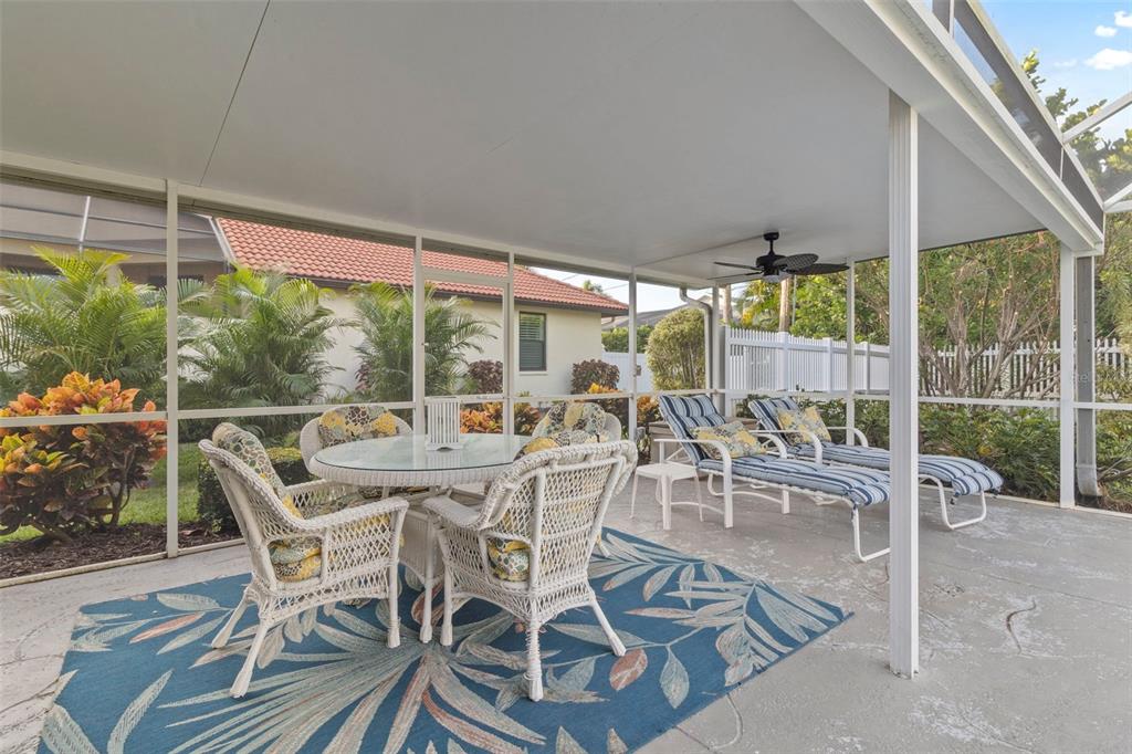 440 Darling Drive Venice, FL 34285 - Photo 32 of 74 a view of a patio with table and chairs and potted plants