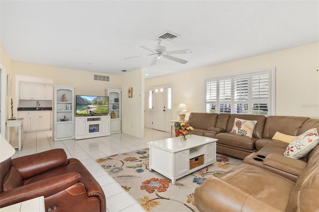 440 Darling Drive Venice, FL 34285 - Photo 7 of 74 a living room with furniture and a large window with kitchen view