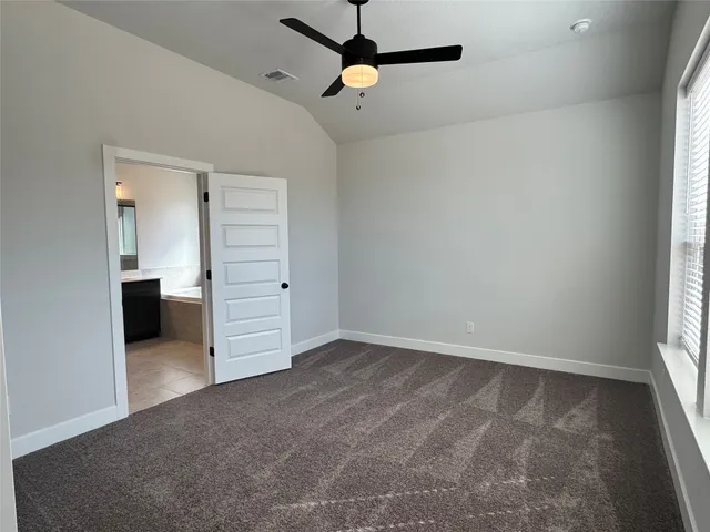 an empty room with closet and windows