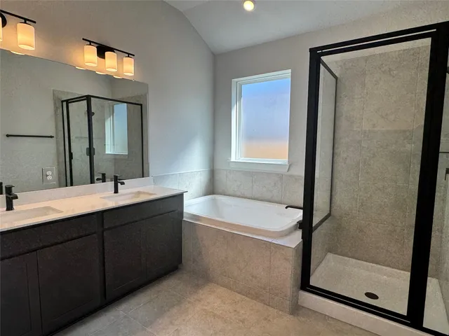 a bathroom with a tub sink and mirror