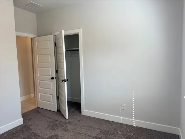 an empty room with closet area