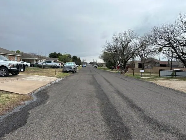 a view of street with parked cars