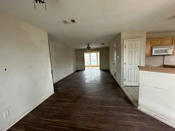 a view of a hallway with the wooden floor