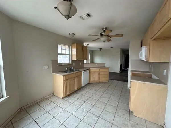 a kitchen with a sink a stove cabinets and counter space