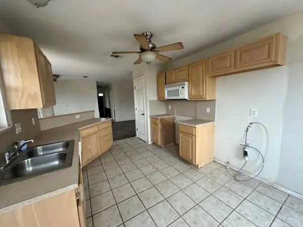 a kitchen with a sink cabinets and appliances