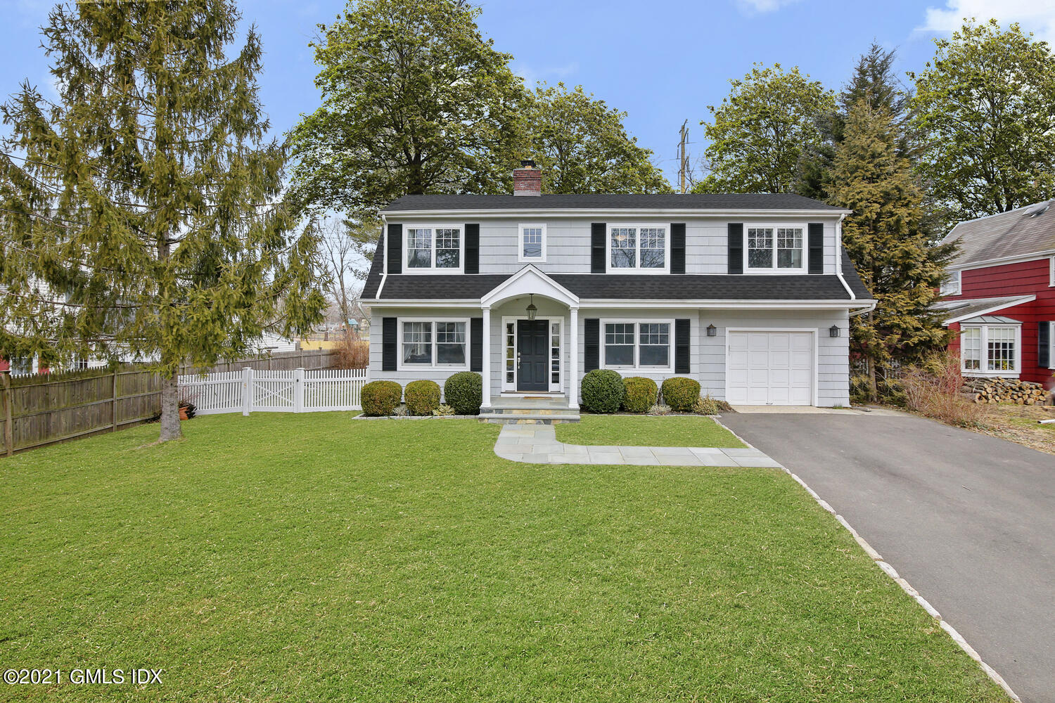 65 Summit Road Riverside, CT 06878 - Photo 1 of 20 a front view of a house with a yard and trees